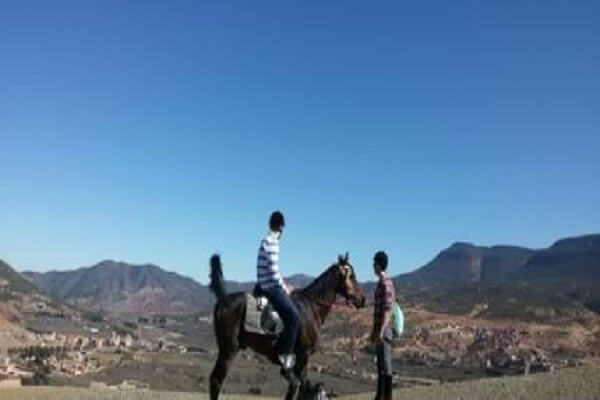 two tourists and one horse in atlas mountains