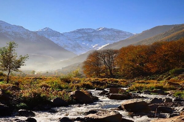 atlas valley treks river in with trees and mountains