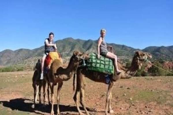 two ladys riding a camel