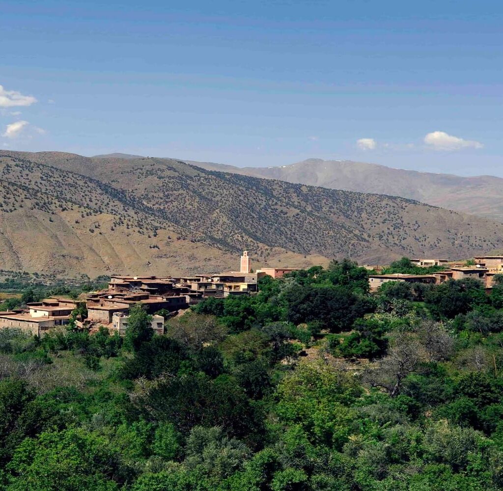 green valley with old buildings in atlas mountains