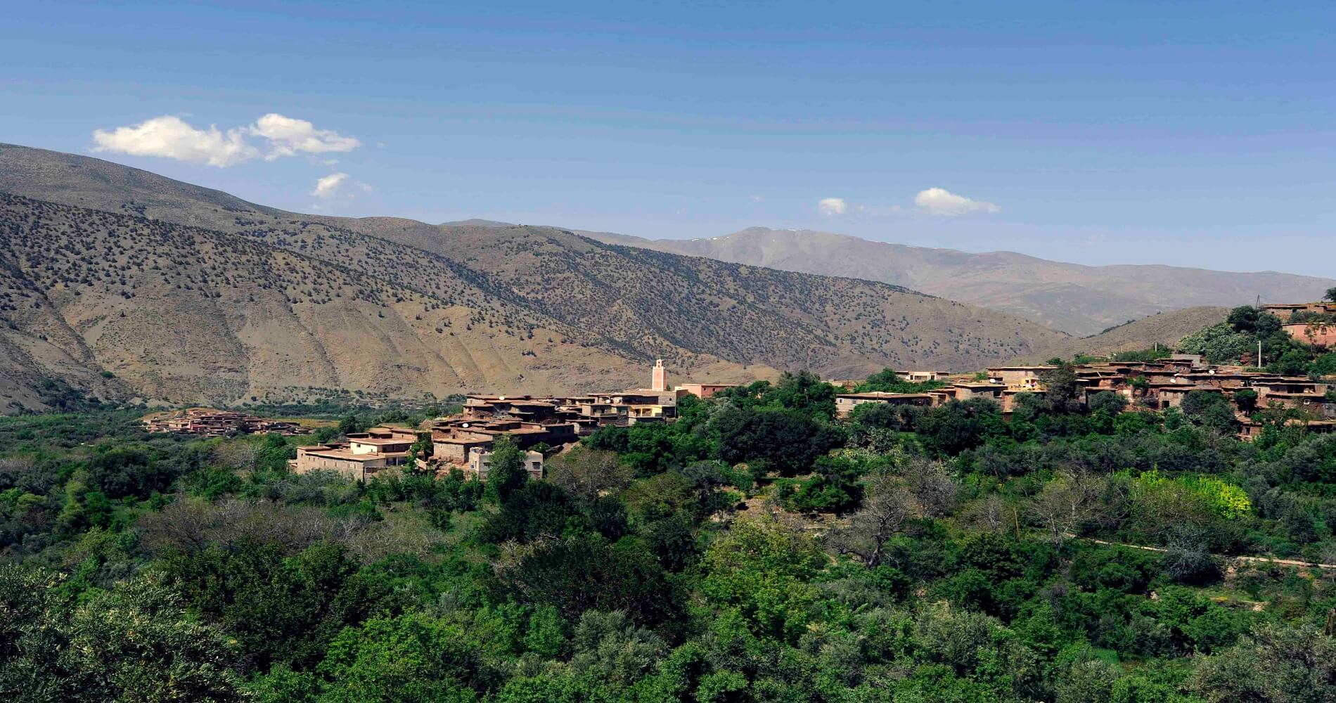 green valley with old buildings in atlas mountains