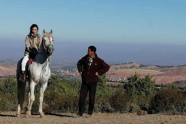 man and lady riding a beautiful horse