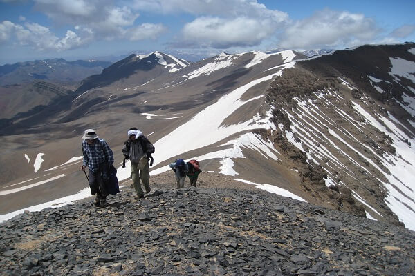 people walking on ridge of mountain in morocco