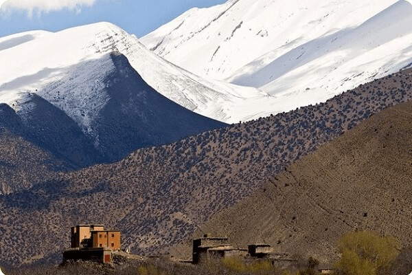 village and snowed mountains in background