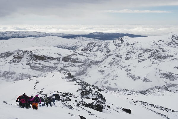 people walking on snow in mount toubkal