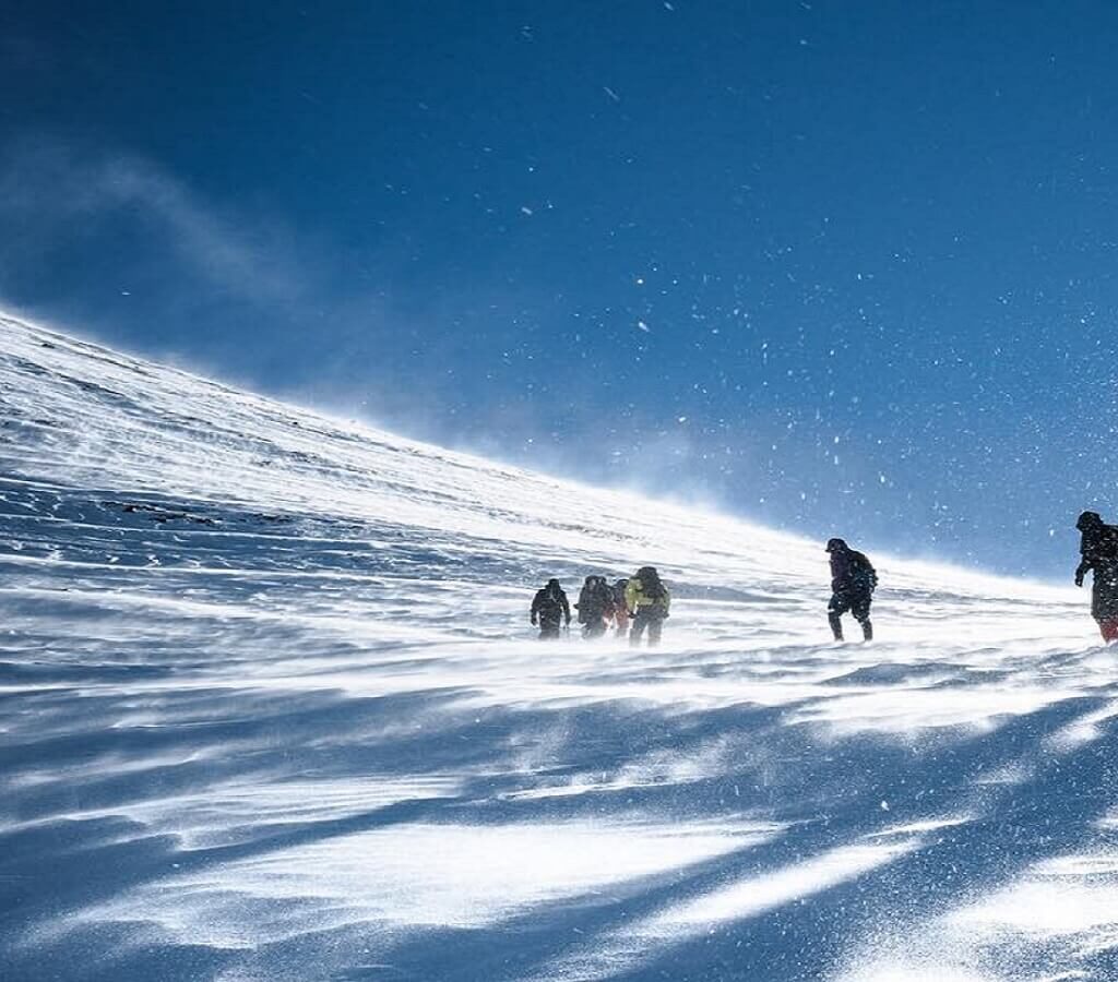 people climbing mountain with snow
