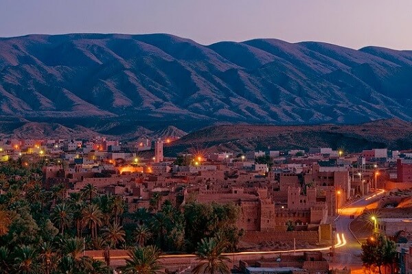 old village by night and palm trees