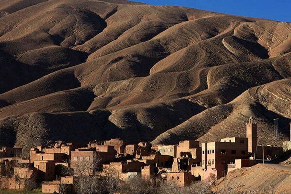 a small vilage and mountains in background