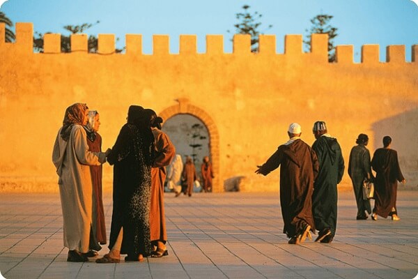 ladys talking near old wall in essaouira