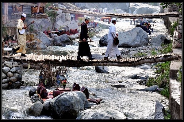 people crossing bridge