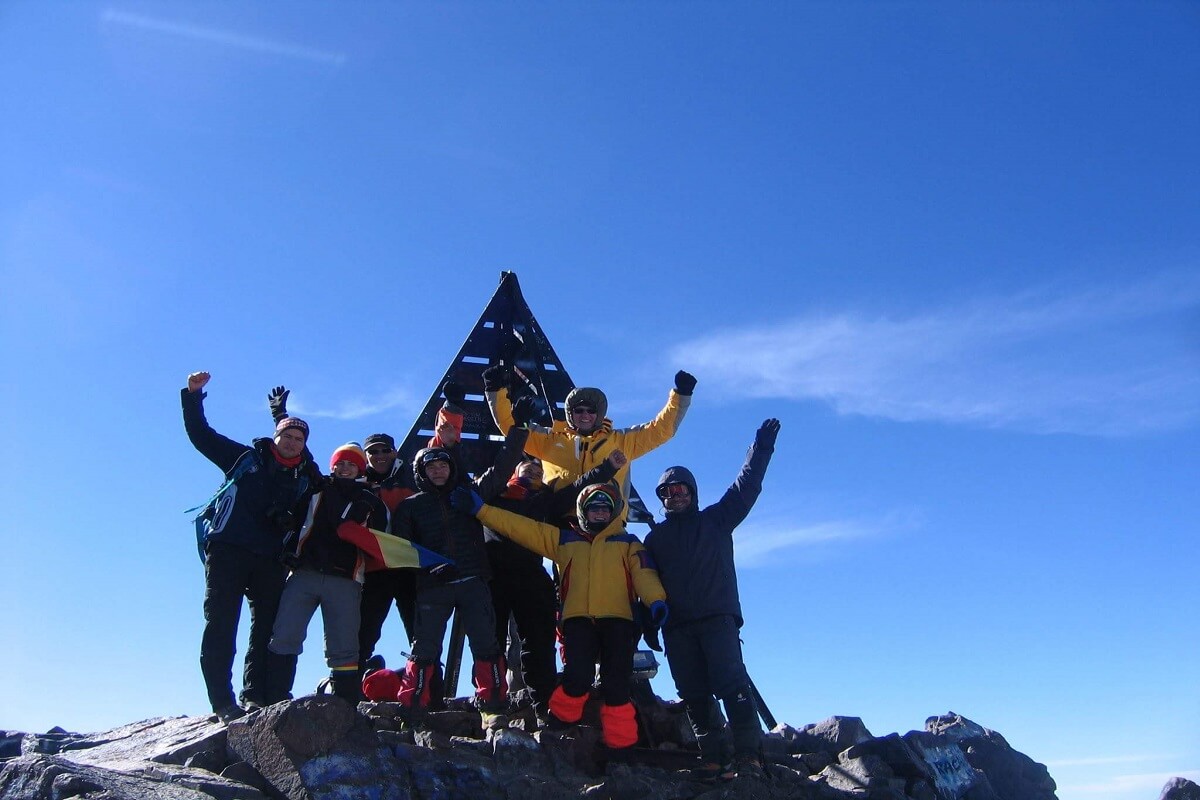 group of people at the summit of toubkal